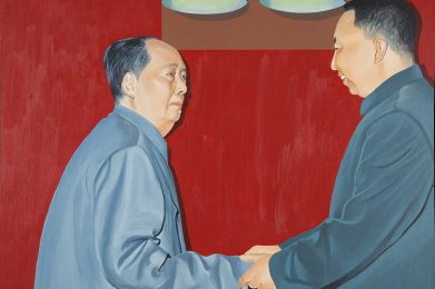 A portrait of Mao Tse-tung shaking hands with a younger Asian man in a grey suit. The man clasps Mao’s right hand in both of his own and smiles. Above their heads two large light fixtures shine downward, casting dark shadows on the deep red backdrop behind them.
