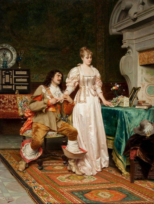 A man with long dark hair and a moustache sits on a decoratively embroidered chair beside a standing woman in a floor length pale pink dress. He holds one of her hands in both of his while gazing up at her as she looks away from him. At her hip there is a table covered in green velvet fabric, on top of which there is a small book and the woman holds a place in the book with her finger.